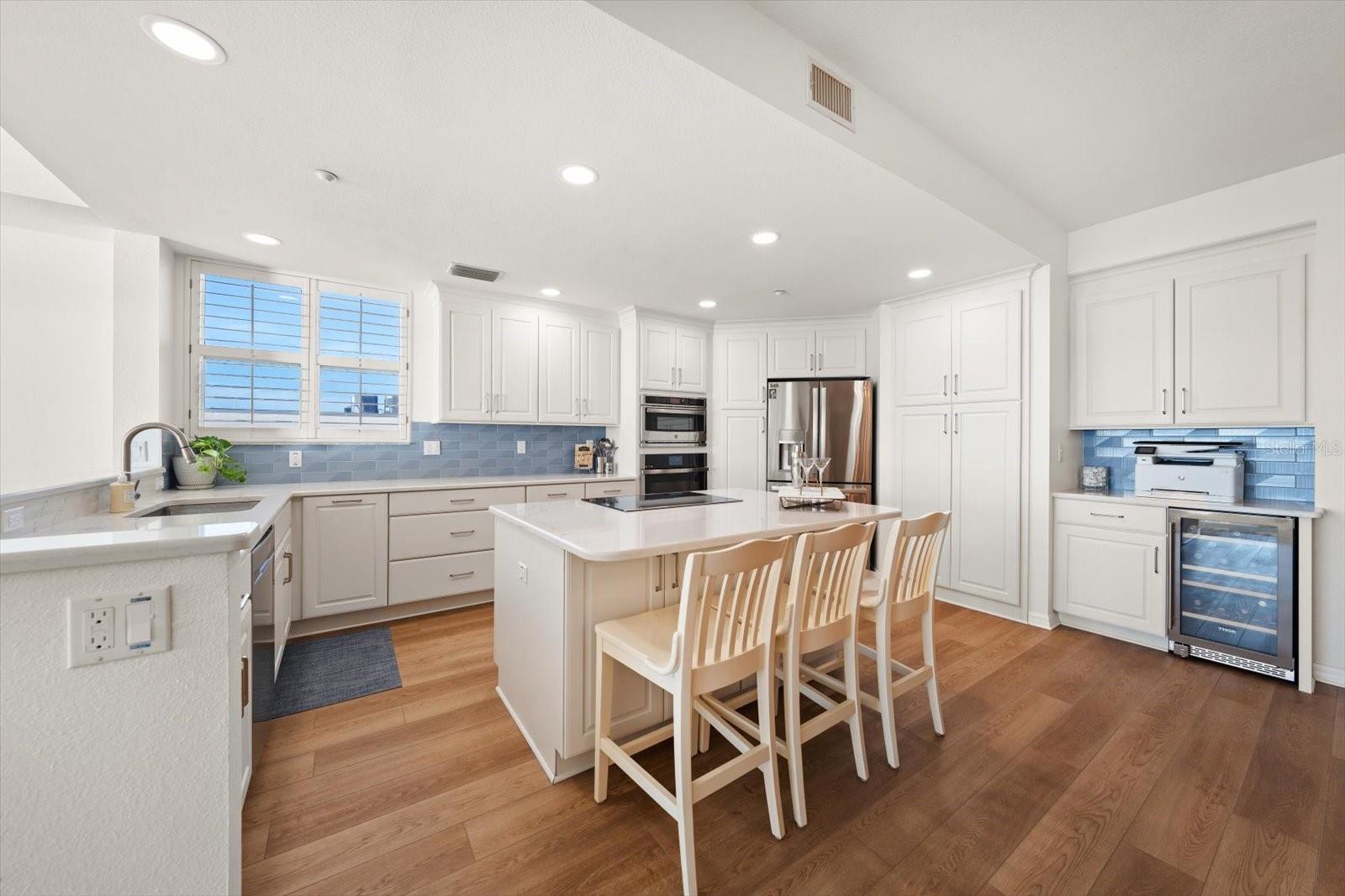 Exquisite kitchen with GE Profile appliances, sleek quartz counters and abundant custom cabinetry.