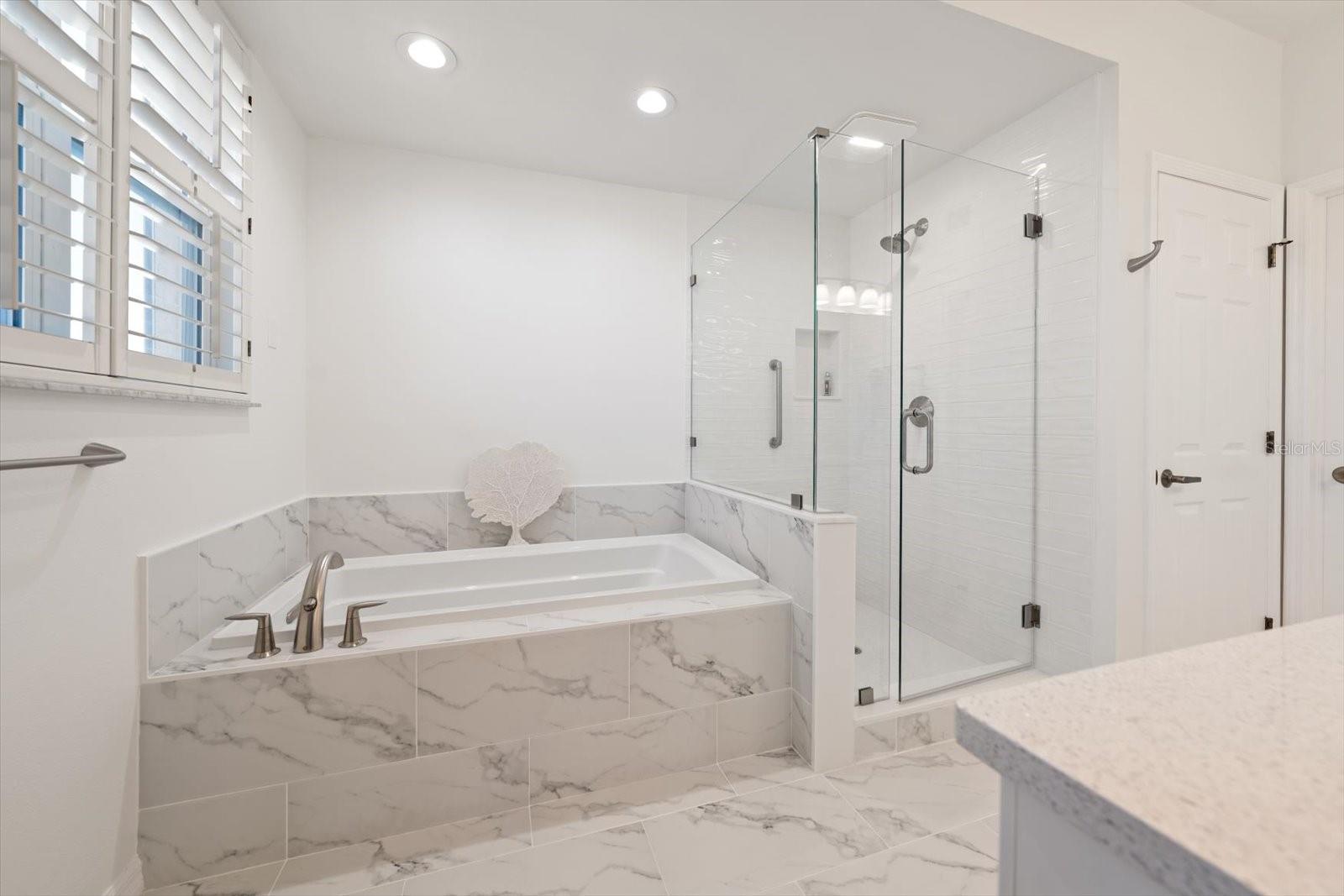 Primary suite with soaking tub and walk in shower-clean and bright.