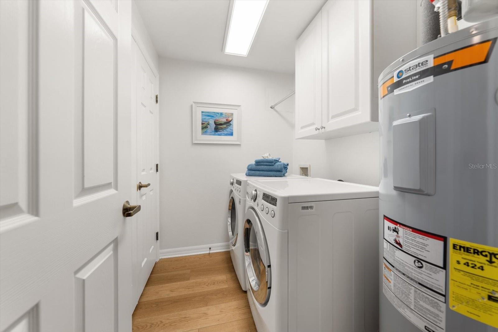 Laundry room has additional storage closet.