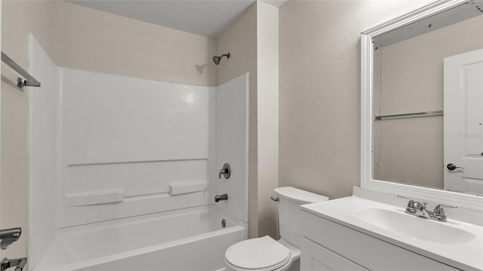 Full guest bathroom that is located between the two secondary bedrooms.