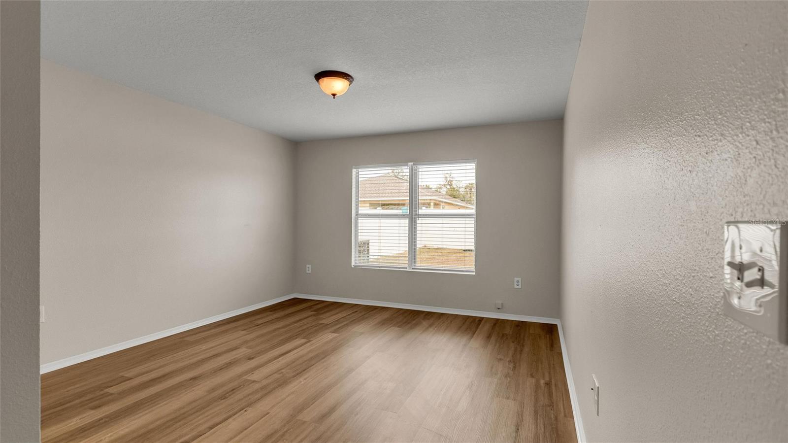 Primary bedroom suite is located behind the kitchen.