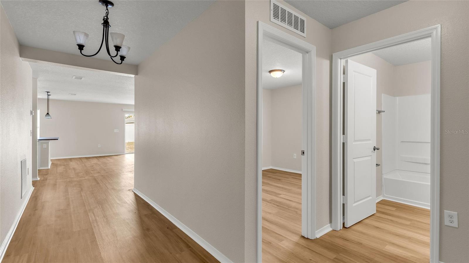 Two secondary bedrooms and full bathroom are located off of the foyer.