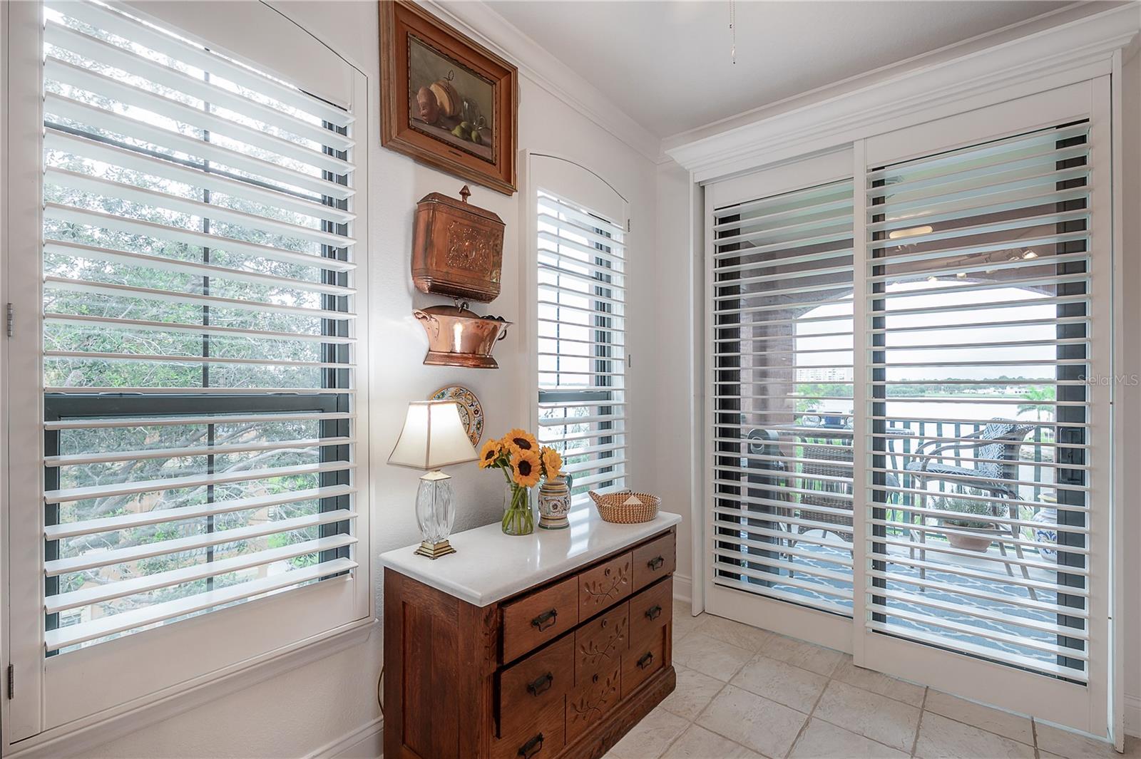 Kitchen and dine-in area overlooking the balcony including the custom wood plantation shutters