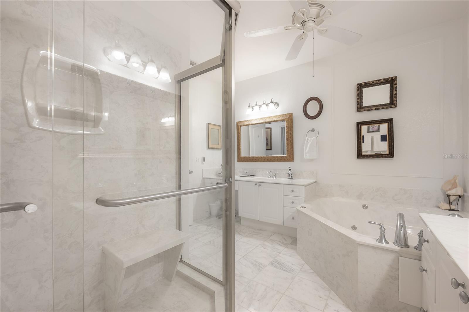Bathroom with marble floors and walk-in shower
