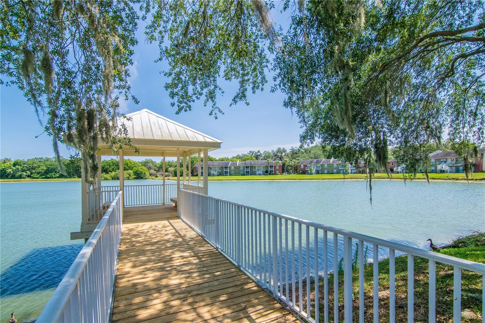Gazebo off of pool going into lake.