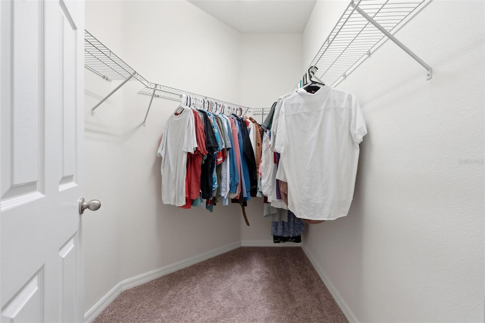 Primary bedroom walk-in closet