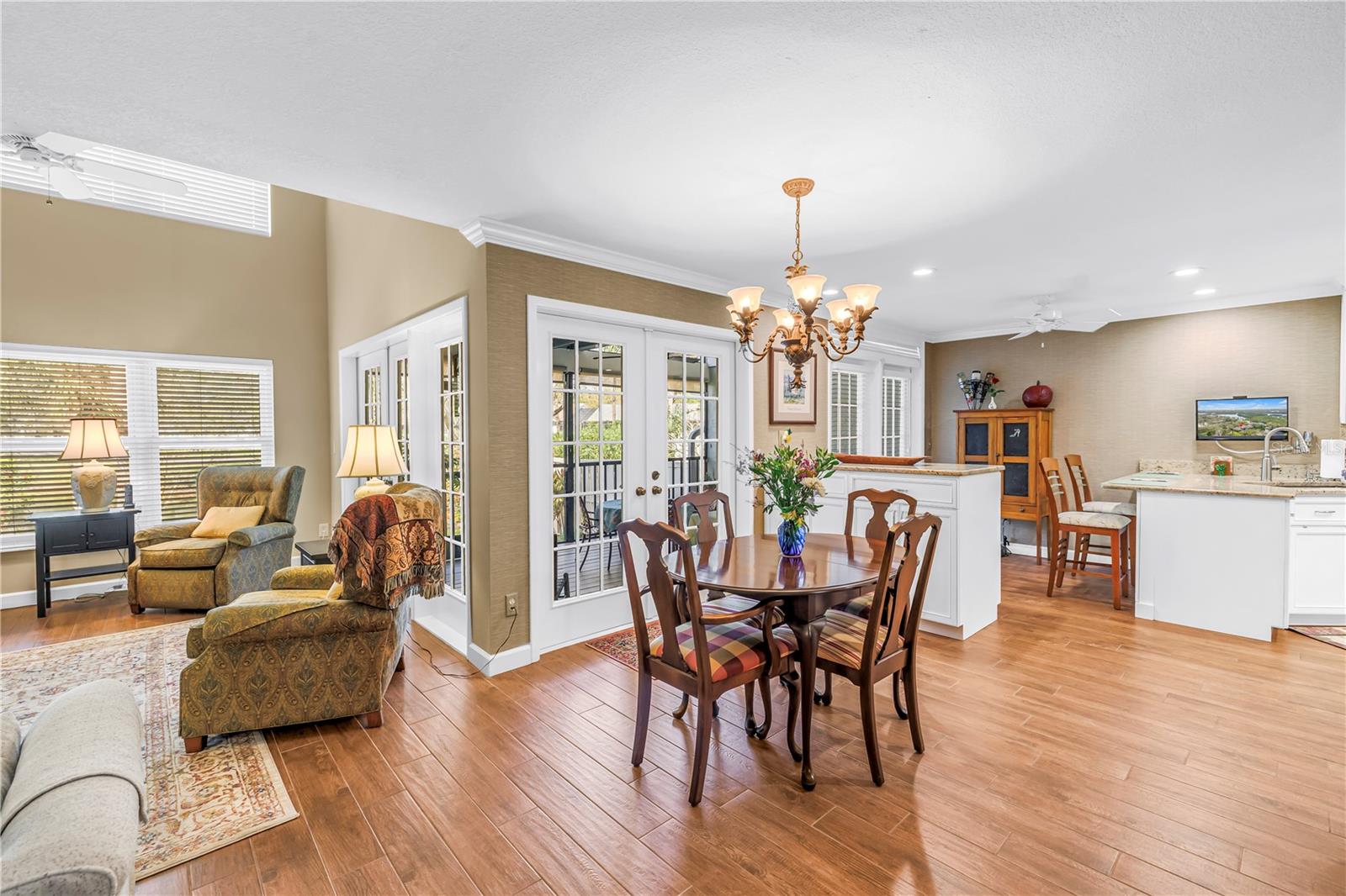 Amazing Open Living Spaces with Wood Grain Porcelain Tile and crown molding throughout the lIving spaces