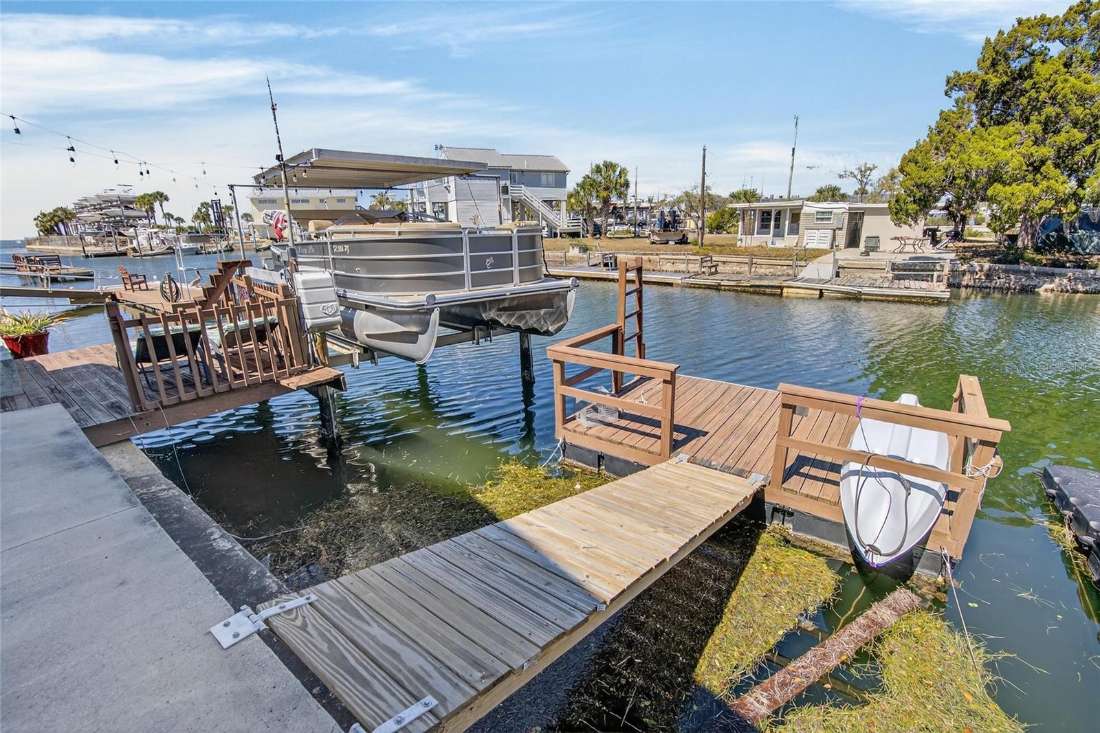 This covered lift is configured for a pontoon, which can be changed for a different boat.  The floating dock will allow you to kayak, paddleboard, etc.