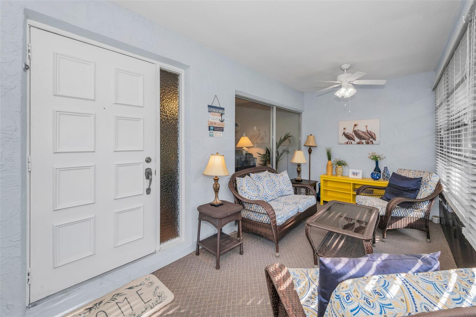 Entry door to home in enclosed porch