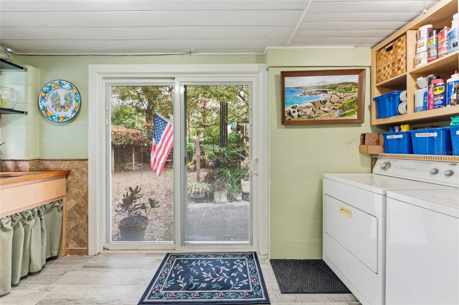utility room with door to back yard