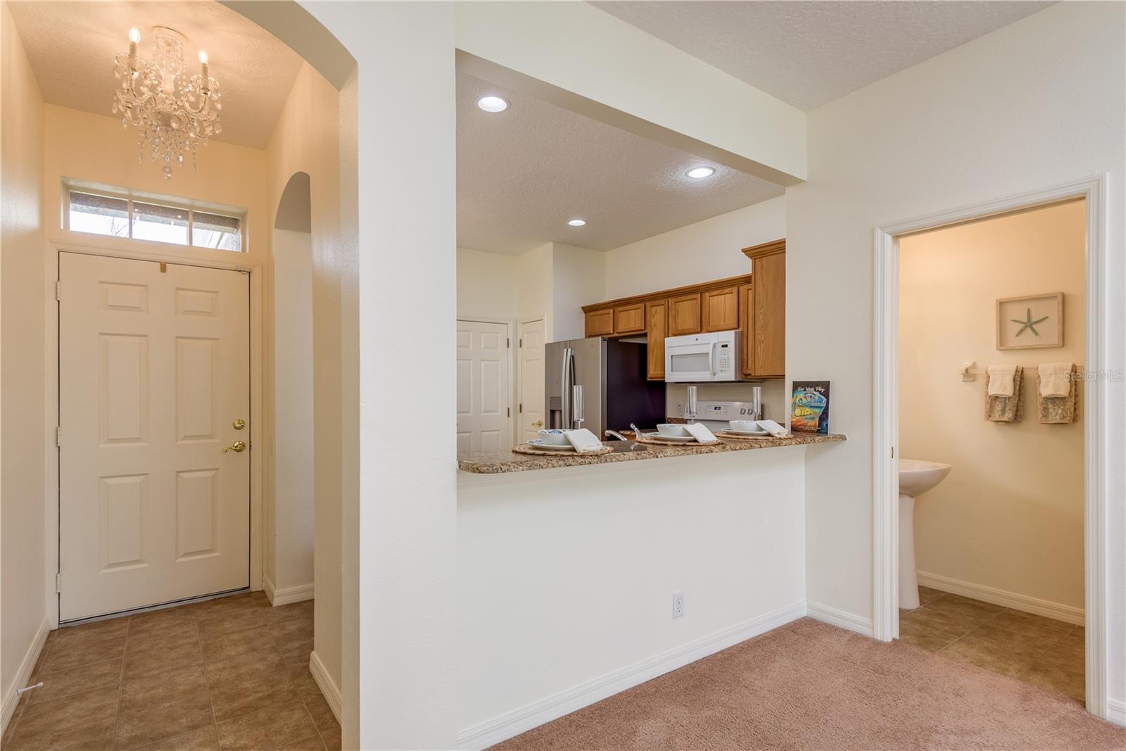 Dining/Living Room Facing Entry, Kitchen, 1/2 Bath