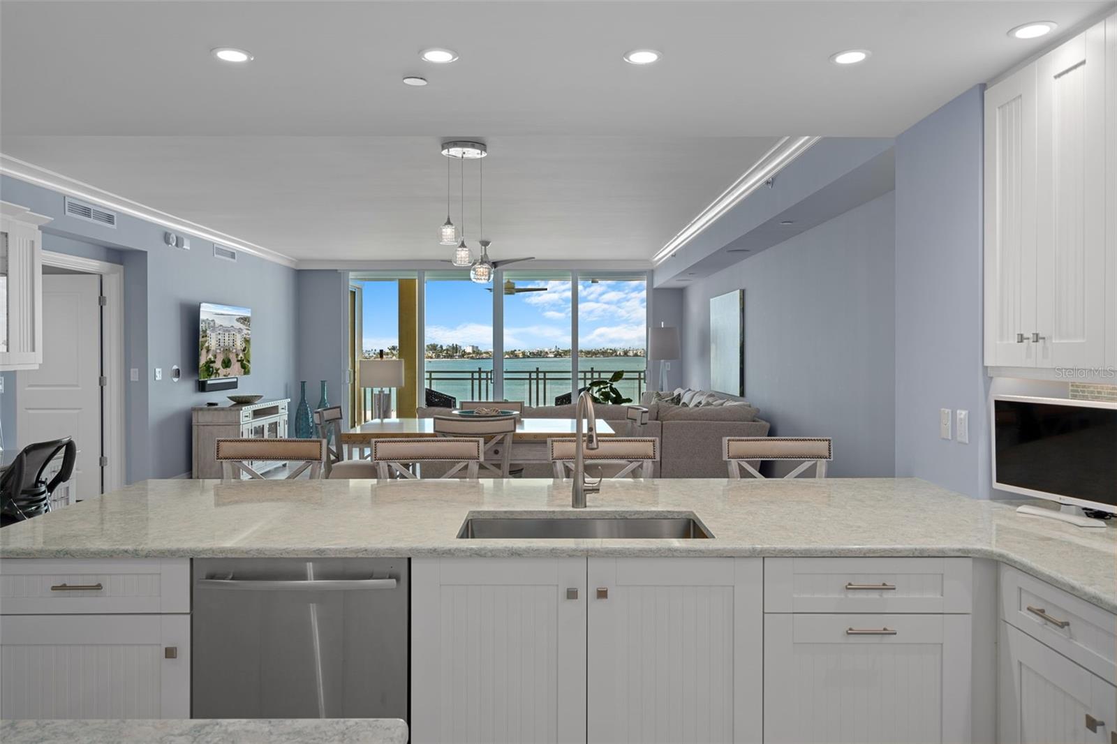 The great room is perfectly oriented to showcase spectacular water views and stunning sunsets.