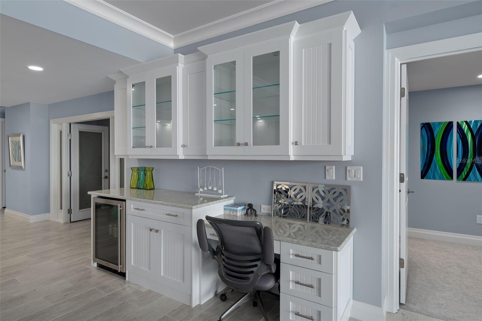 The beverage refrigerator and glass front cabinets provide a convenient location for wine glasses and cold white wine.