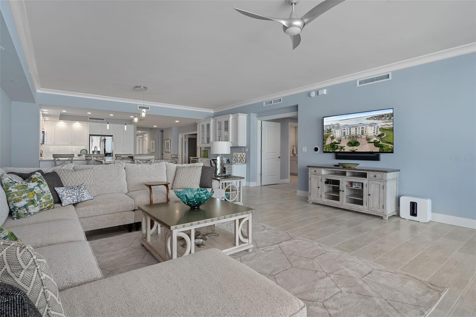 The generous great room with a view toward the double-door primary suite entry.