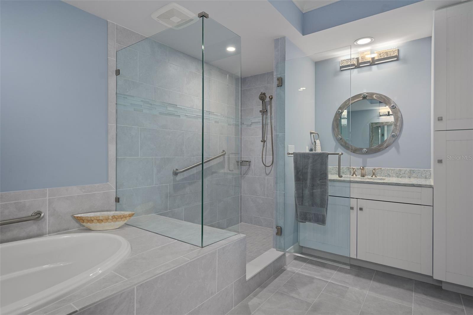 The primary suite bath features custom cabinetry including a spacious linen closet.
