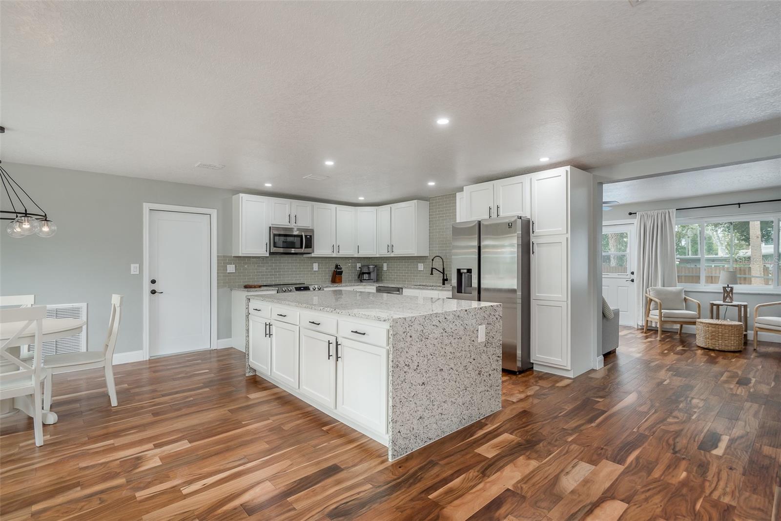 Spacious Kitchen and Dining room with laminate flooring.