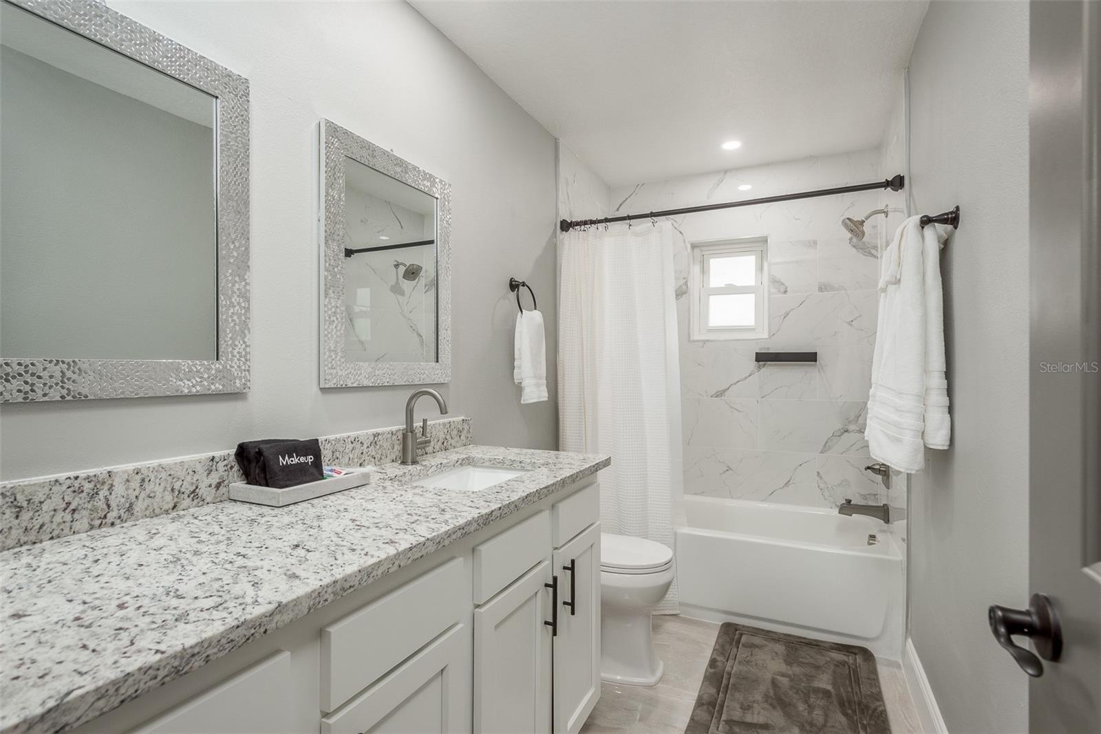 Second Full Bathroom with tub shower and large single vanity. Enjoy Porcelain floors!