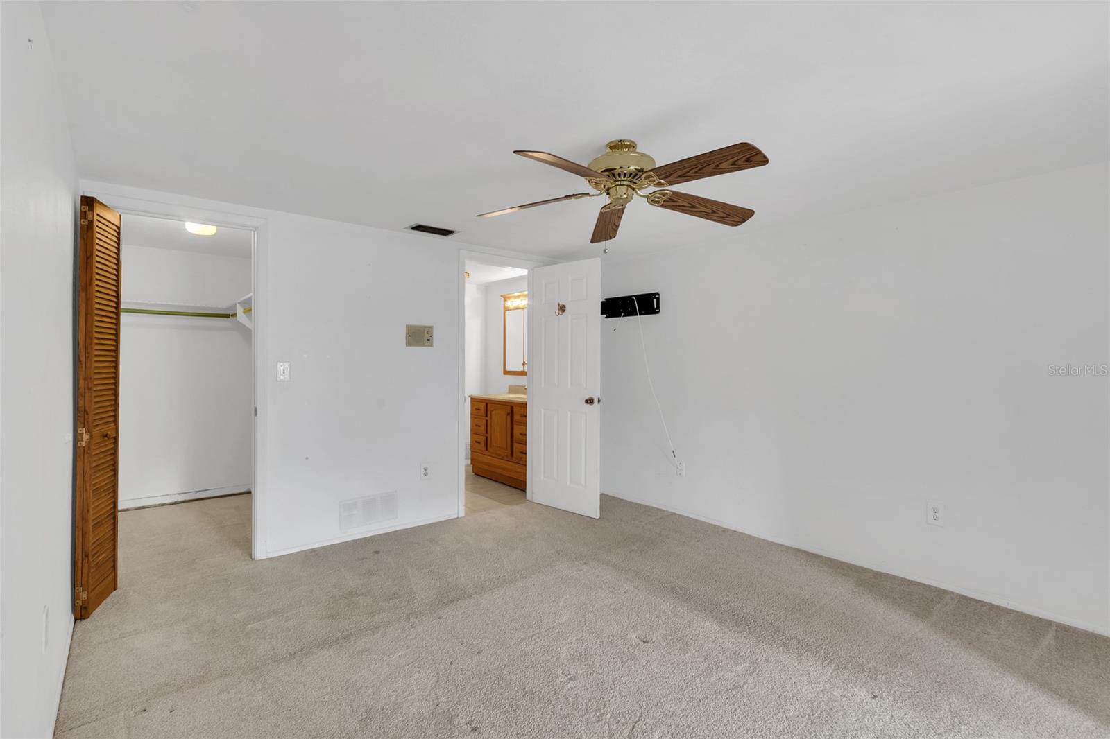 Primary suite with view of walk-in closet and bathroom