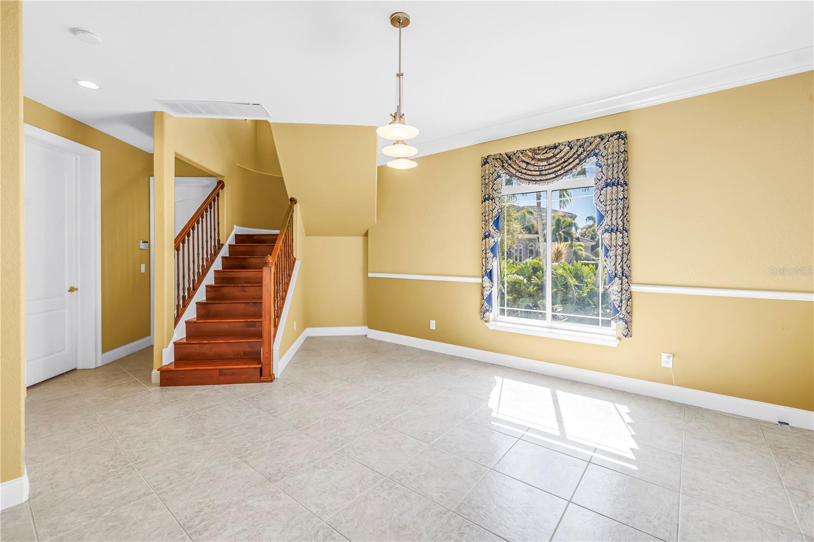 Formal dining area and stairs to main bedroom