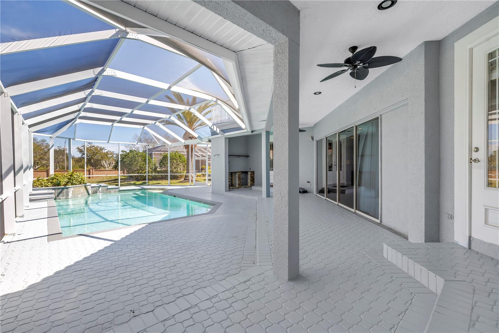 Covered outdoor areas surround the pool
