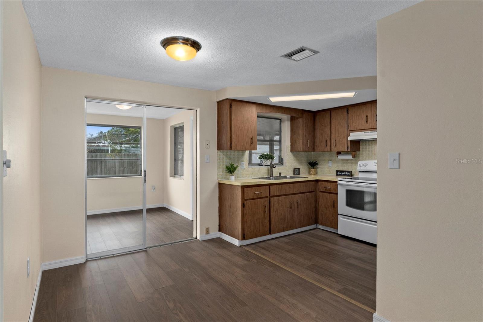 This view shows the dining room and the kitchen