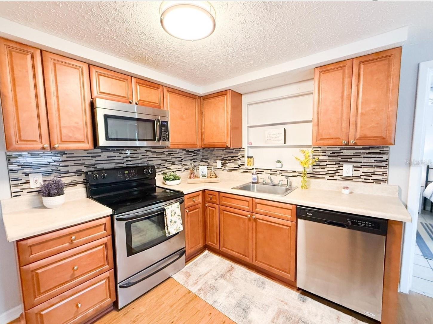 Solid Wood Kitchen Cabinets and Stainless Steel Appliances