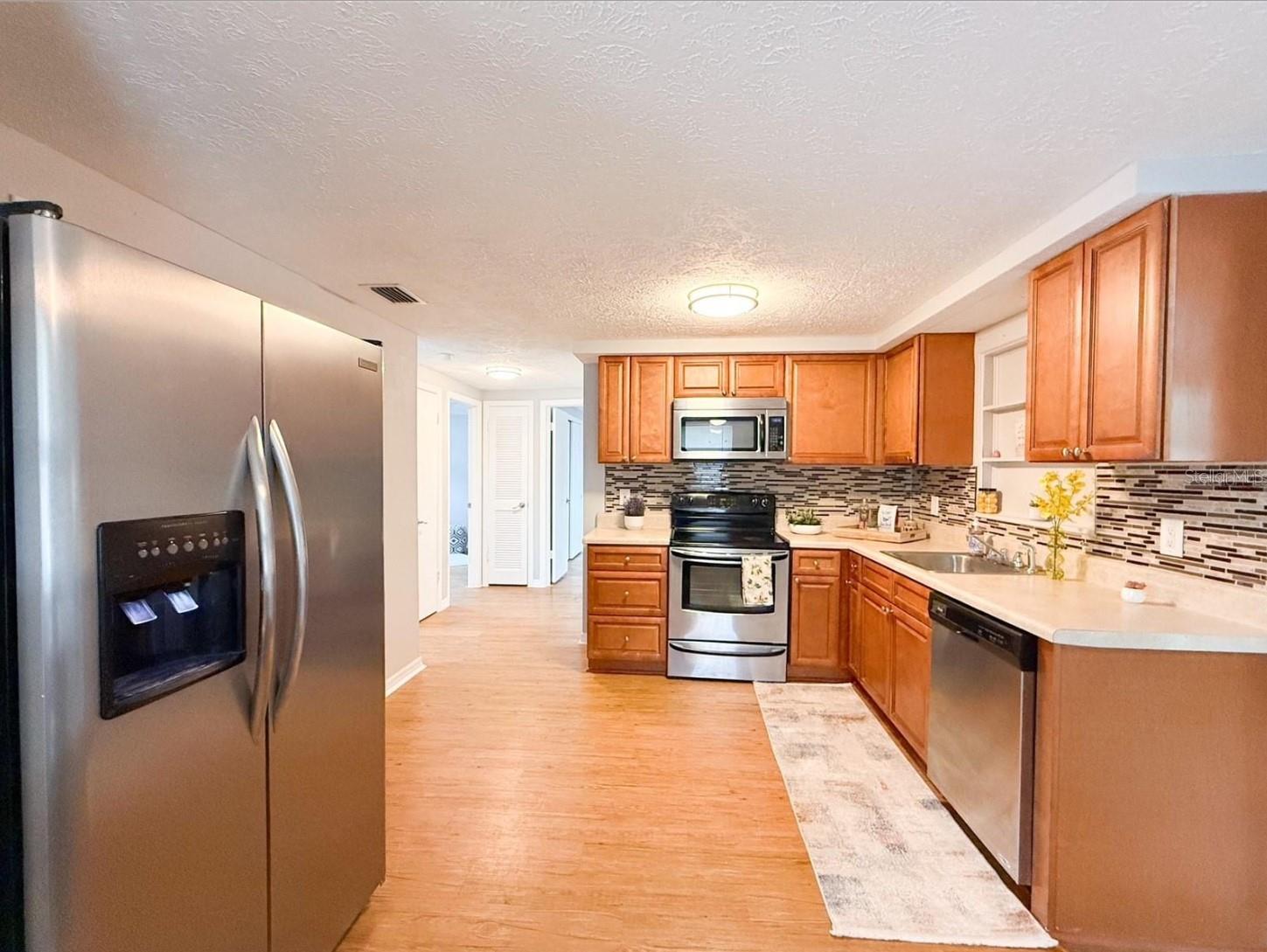 Solid Wood Kitchen Cabinets and Stainless Steel Appliances