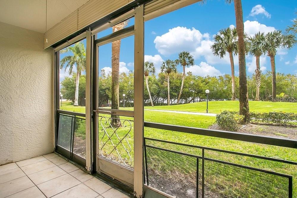Screened in porch looks out to the marina and greenspace