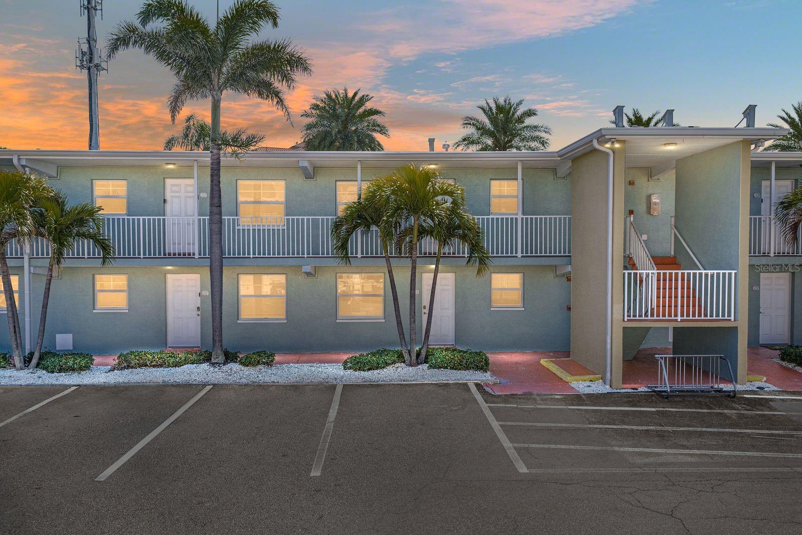 Front of building F. Door is directly behind the W shaped palm