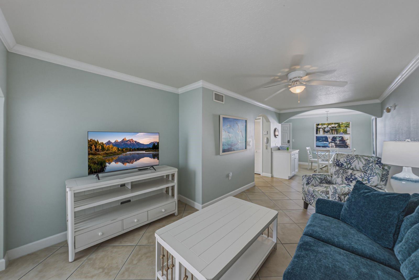 View of living room towards dining room. Furnished as seen.