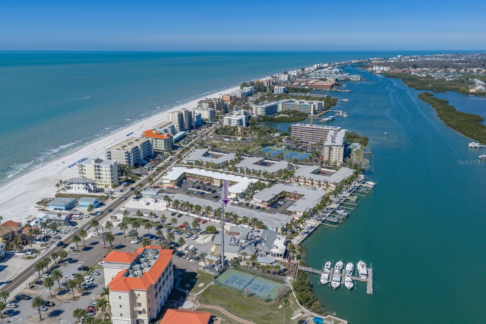 Barefoot beach resort is on Indian Shores, sandwiched between the Intercoastal and Gulf of America. Purple arrow points at the location of your new condo.