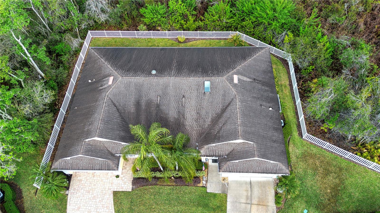 Note fence around condos separating from wooded area.