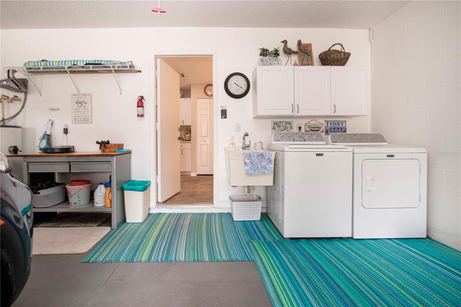 Laundry area with sink and work bench