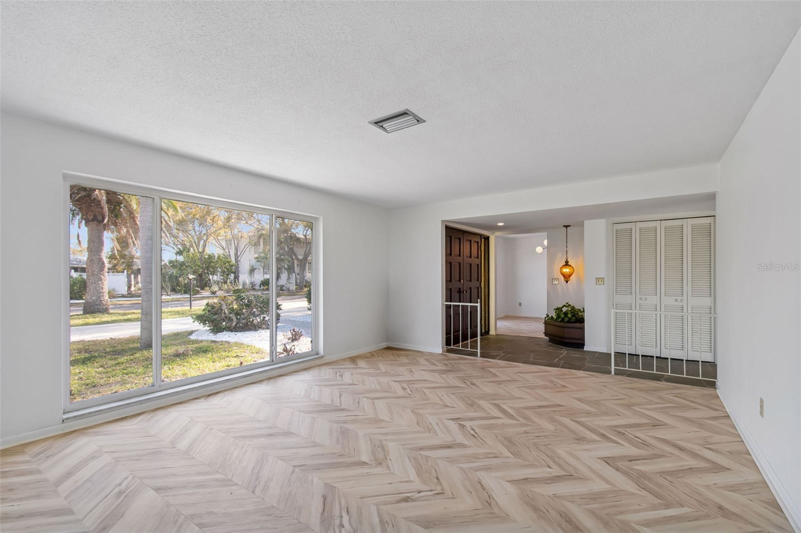 Another view of Living Room..check those new floors and fresh white paint throughout
