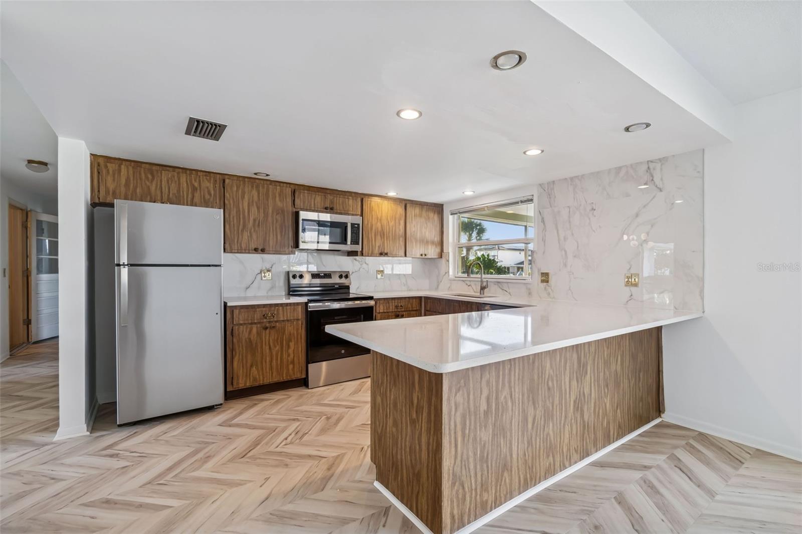 New countertops, backsplash, sink and stainless steel appliances