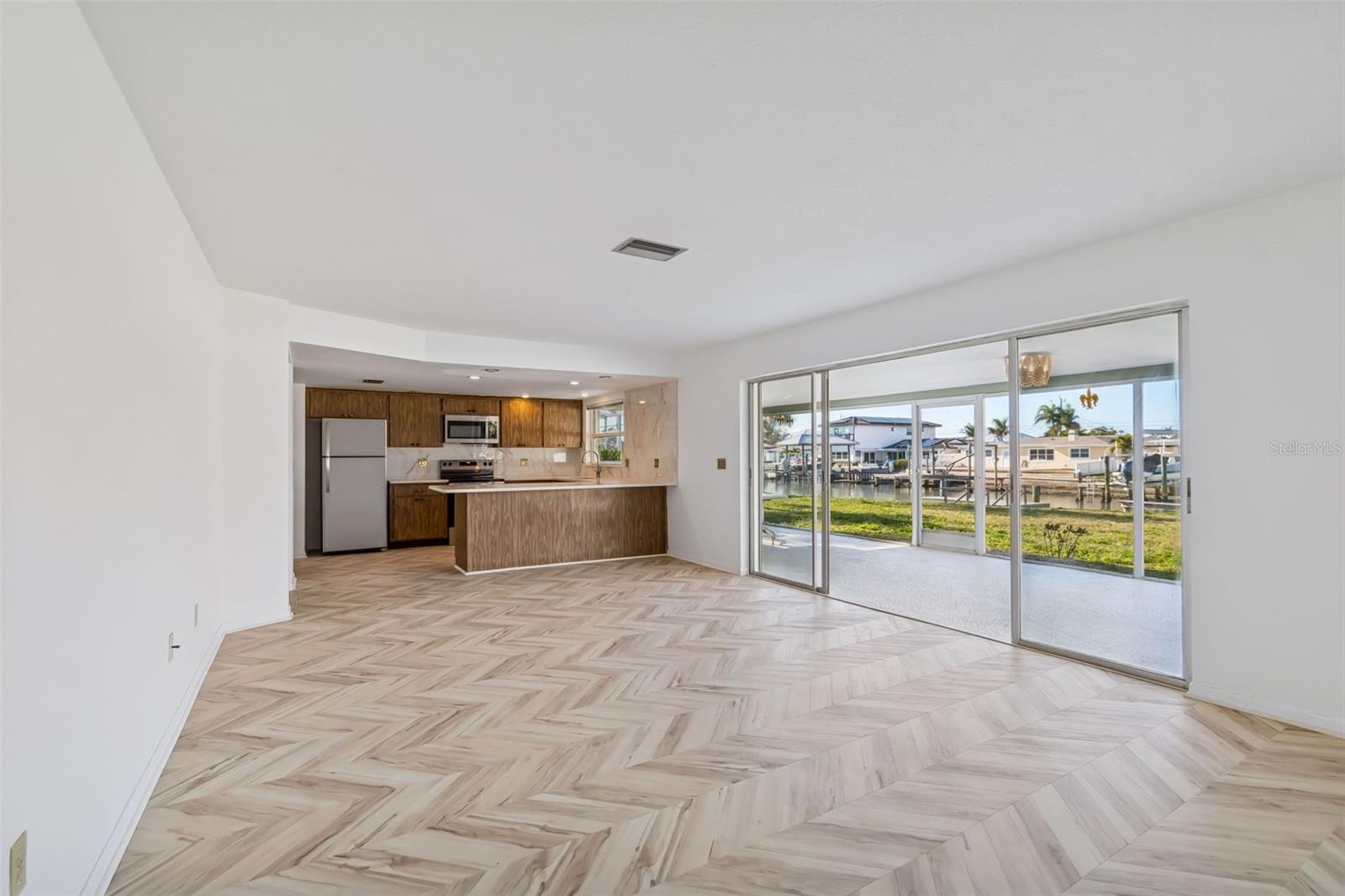 Notice the new chevron design LVP flooring in the family room.