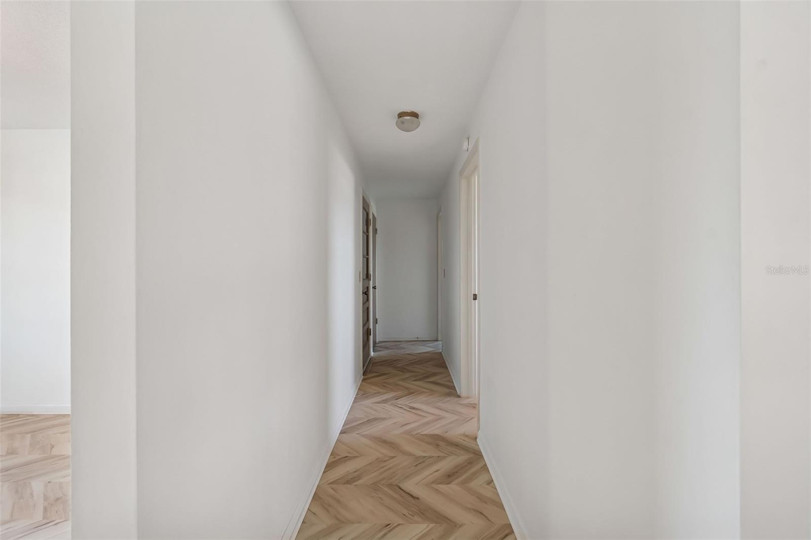 Hall to office, garage and primary suite