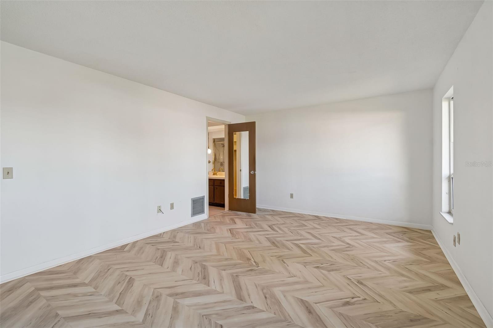 Primary bedroom with door to ensuite bath