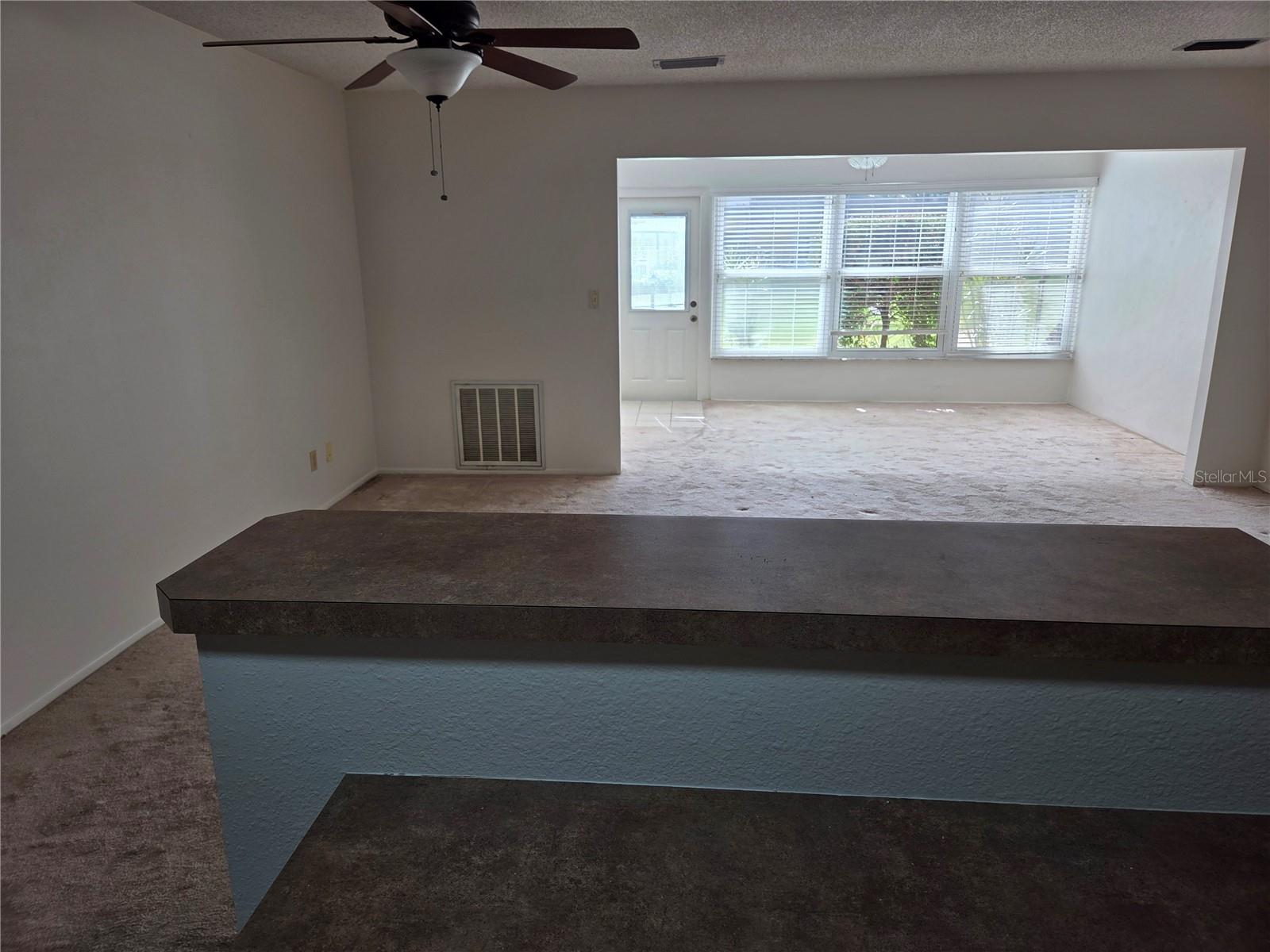 Living Room and Florida Room View From Kitchen Breakfast Bar.