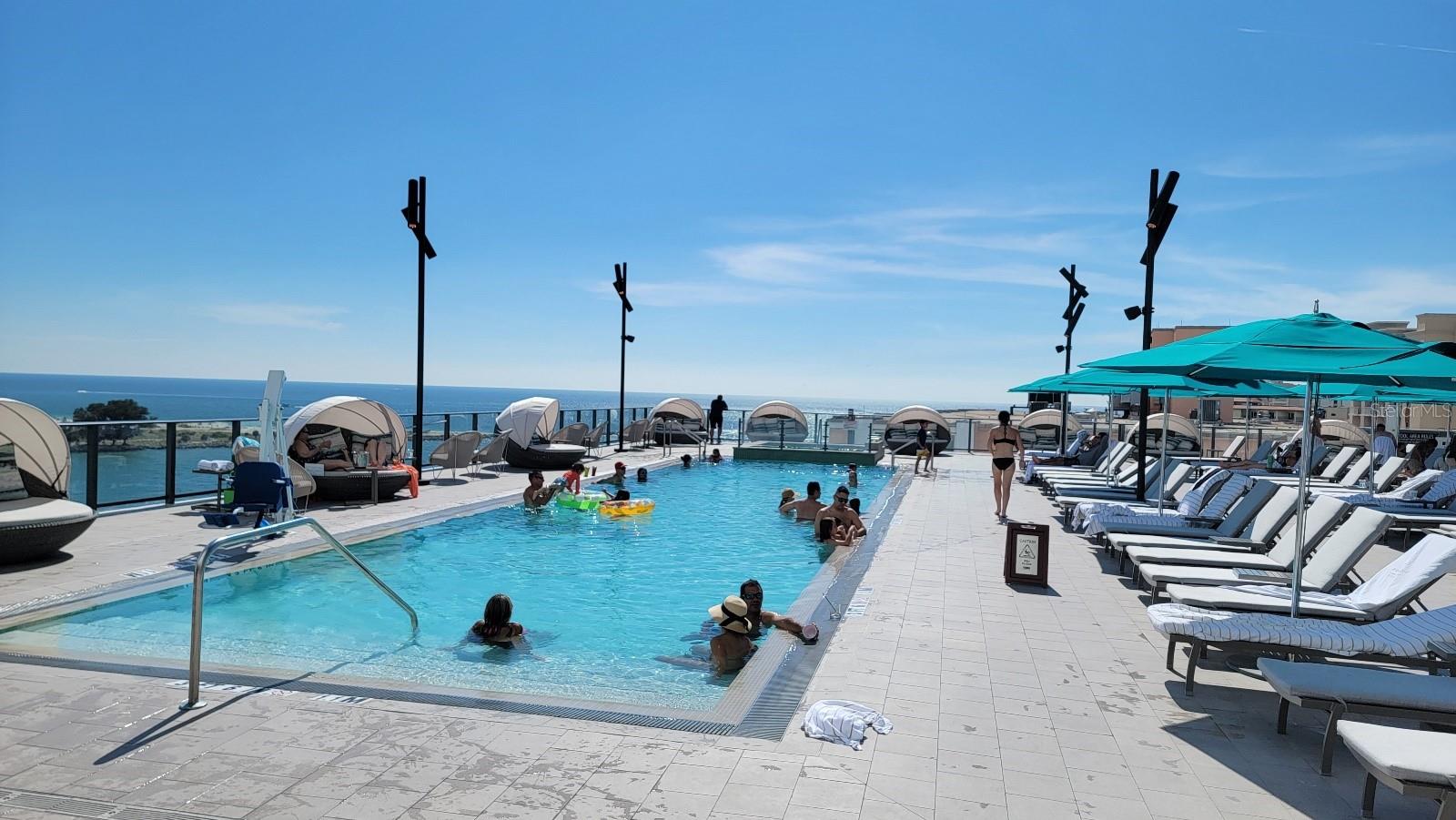 elevated pool & hot tub floor next to the biggest poolside restaurant bar you may come across