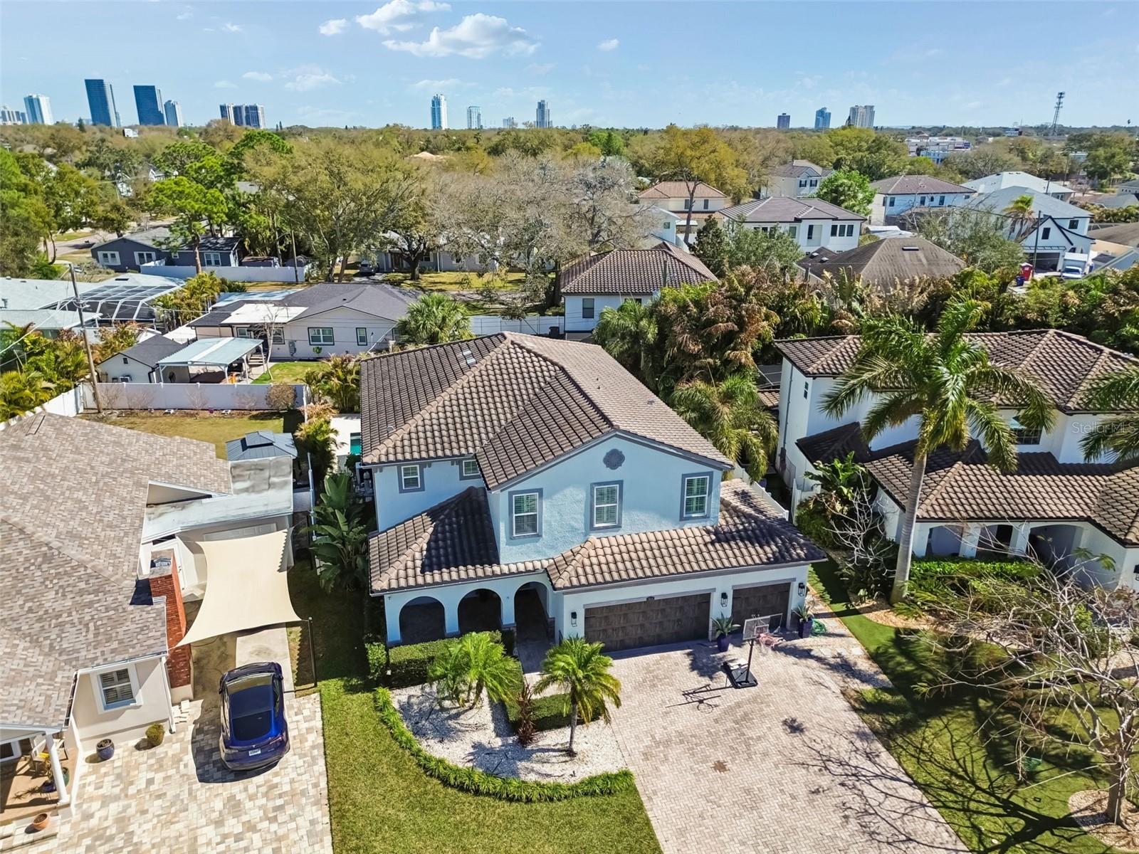 Tropical landscaping and palms highlight the home’s striking curb appeal. Near Downtown.