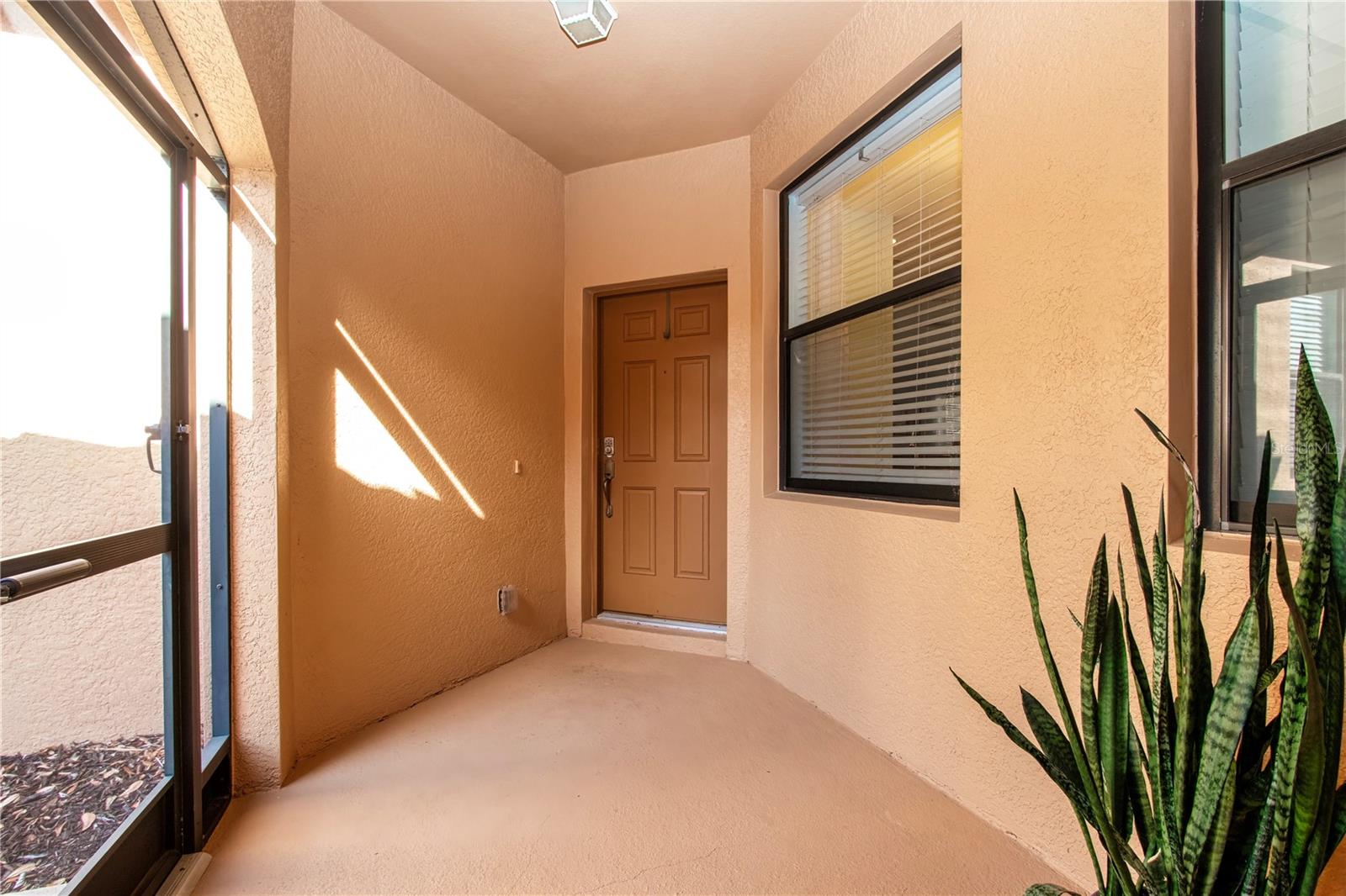 Covered, enclosed front porch perfect for deliveries