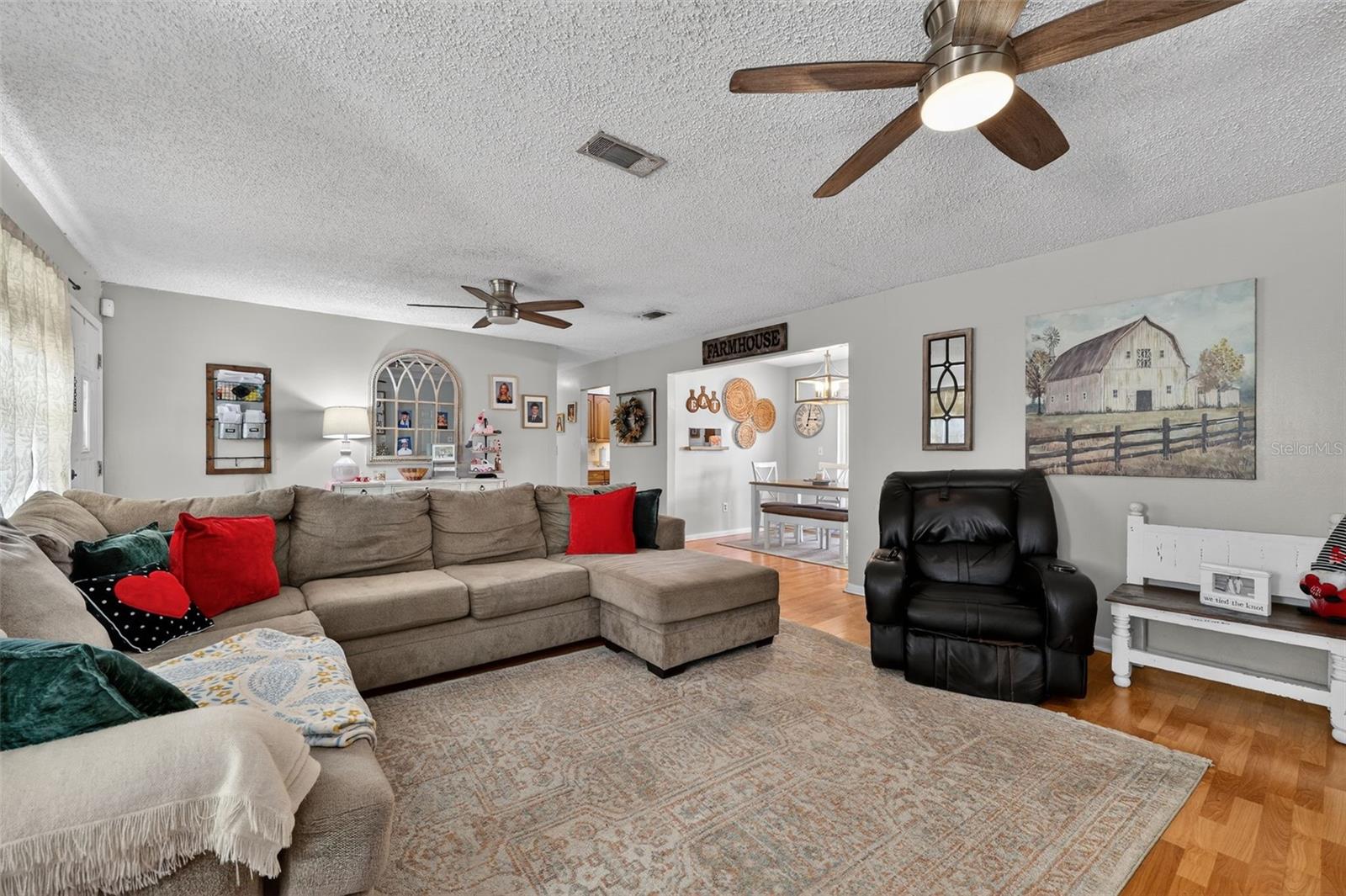 Expansive Living/Family Room with fans, laminate flooring.