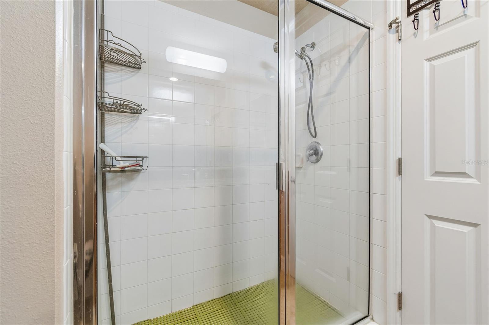 Primary shower with glass door and shower floor protection