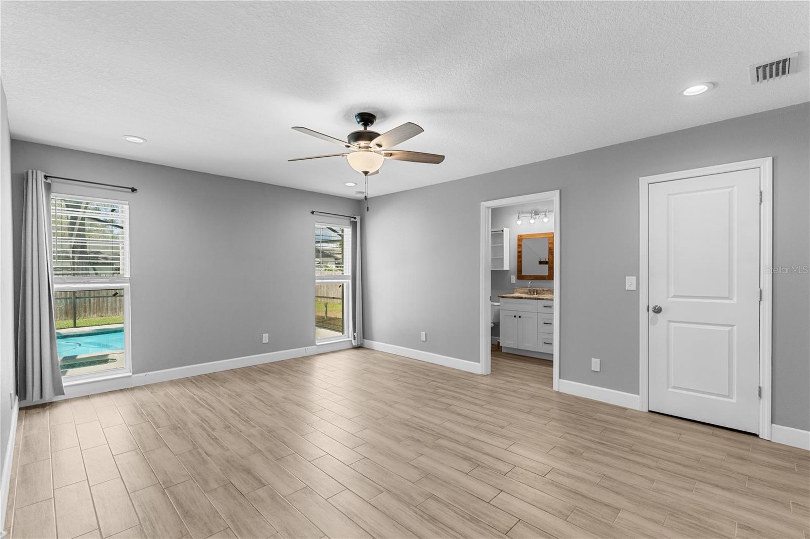 Primary bedroom with pool view