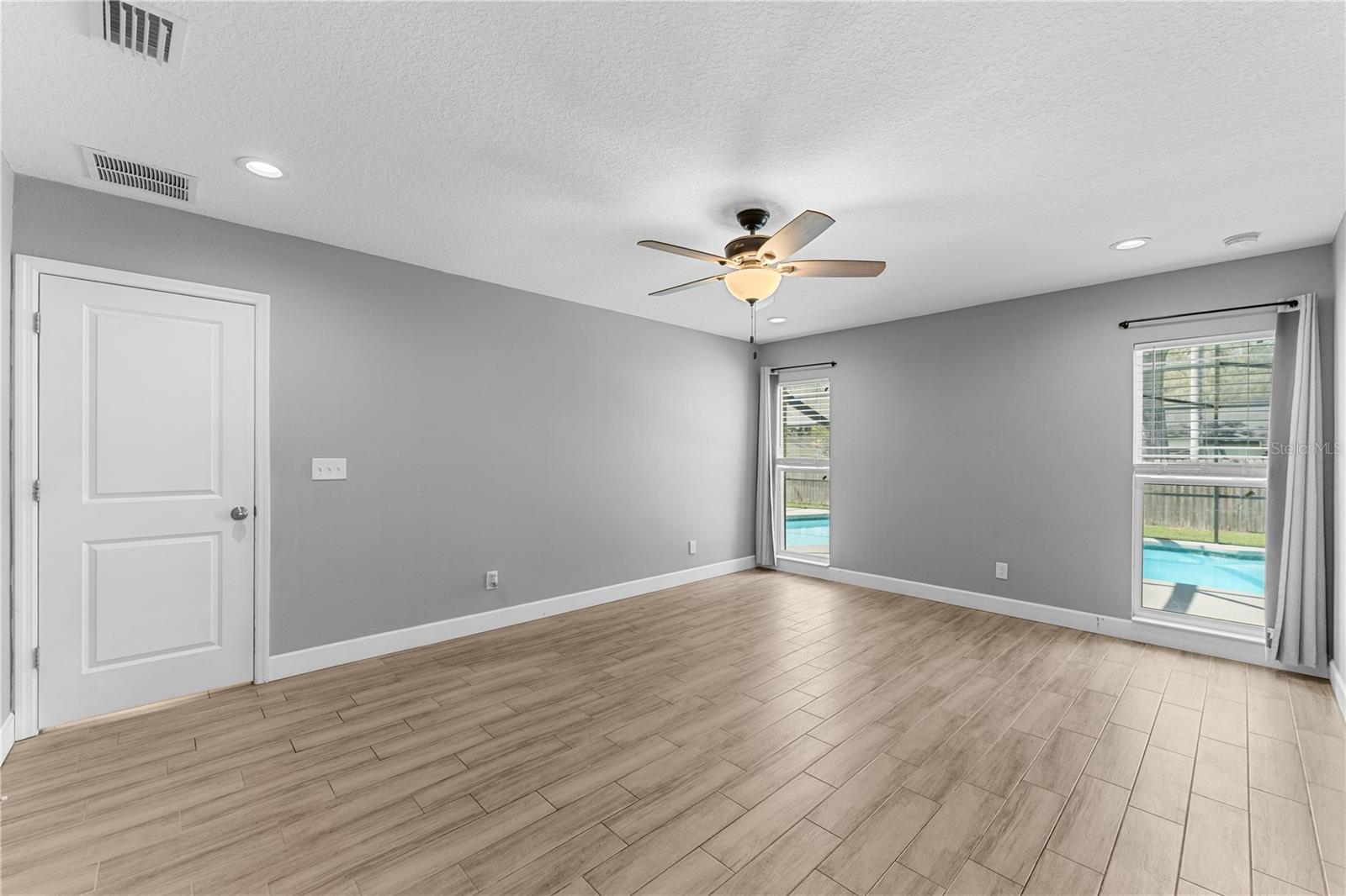 Primary bedroom with pool view