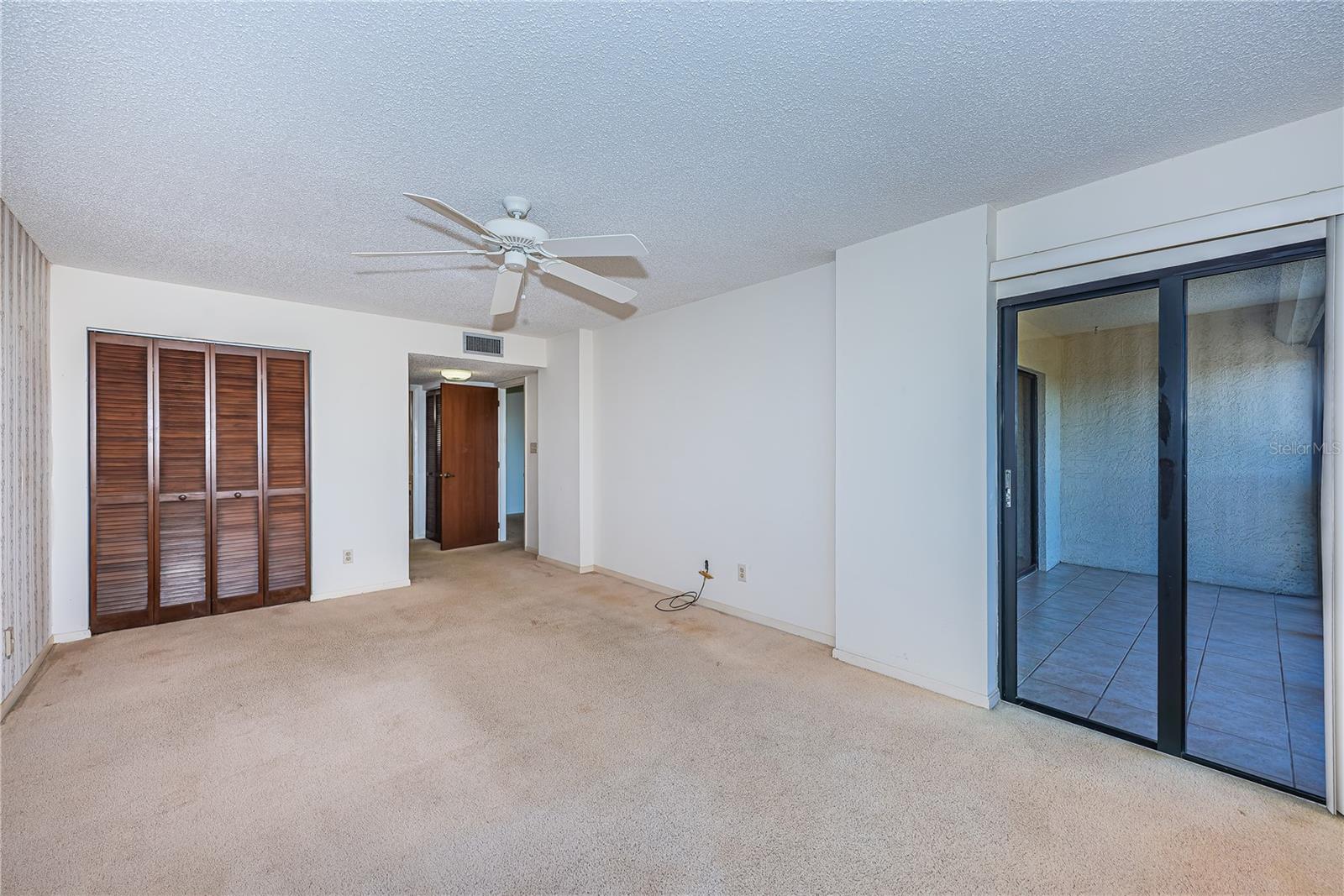 primary bedroom with sliding doors to balcony
