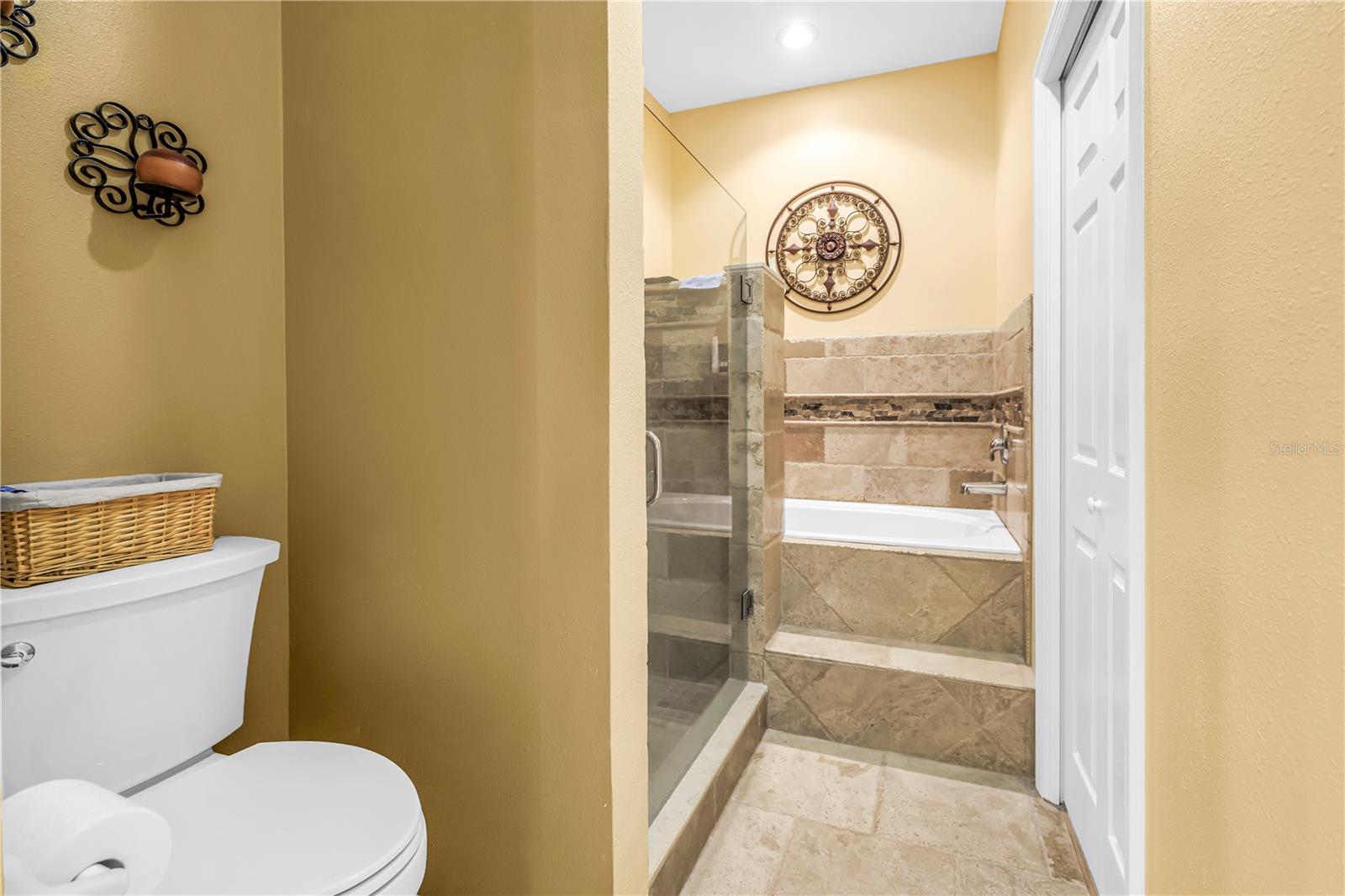 Travertine floors, shower and tub surround.