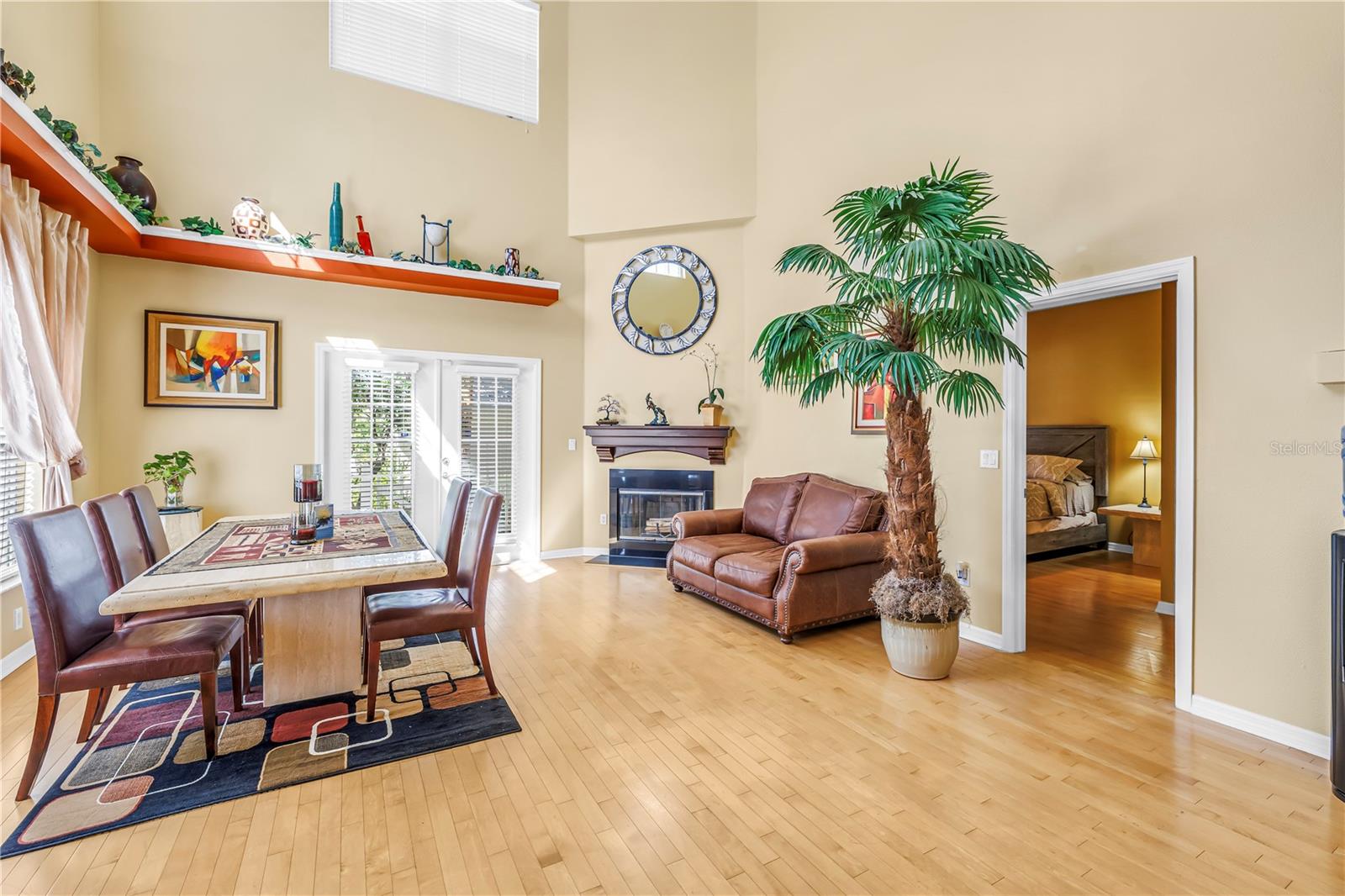 First floor living and dining area.  French doors open to private covered patio.