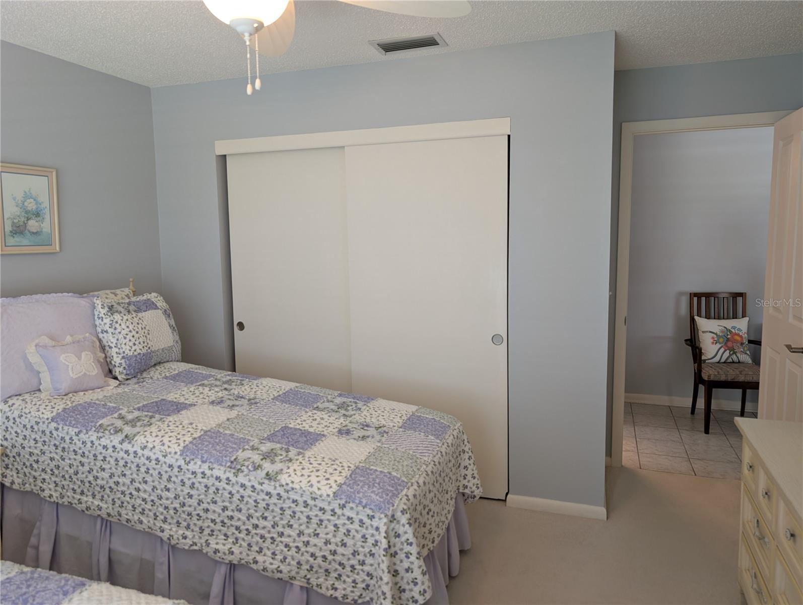 View of main bath entry to left, living room to right.